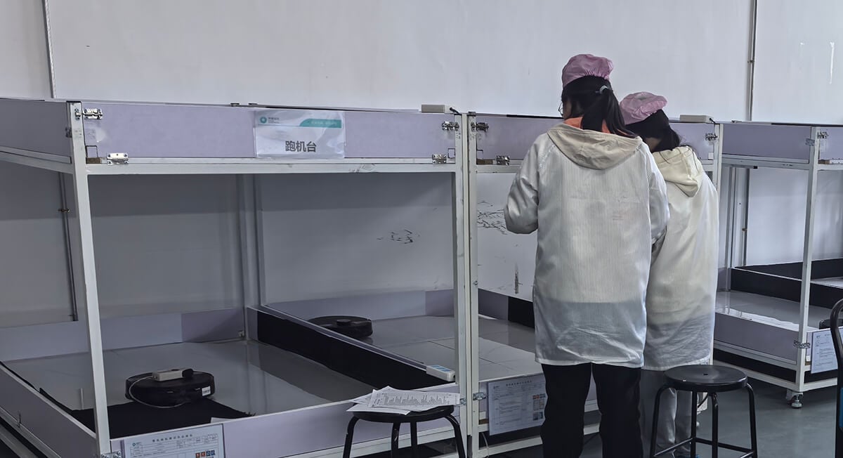 Minfu quality control engineers testing robot vacuum durability and navigation in our advanced reliability lab